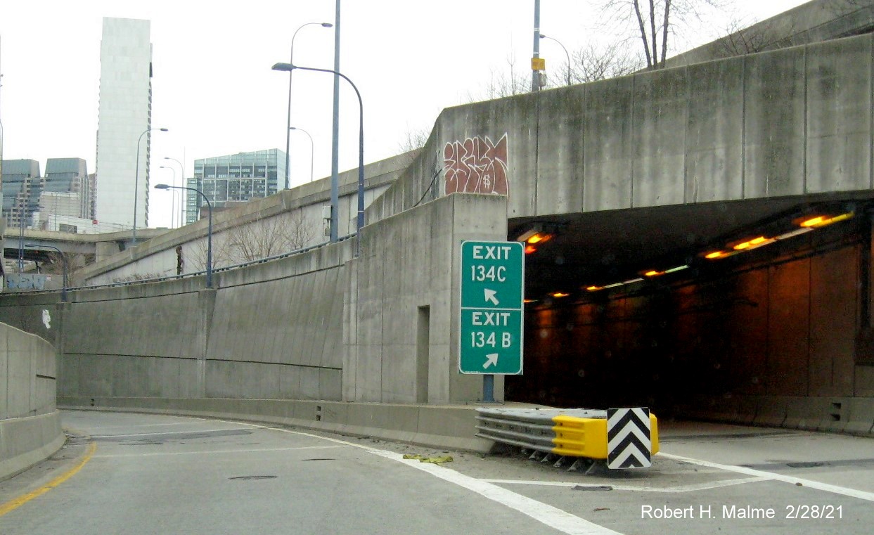 Image of gore signs for I-93 and South Boston exits with new milepost based exit numbers on I-90 
                                         East in Boston, February 2021