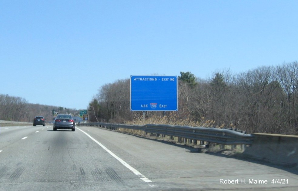 Image of blue Attractions services sign for I-290/I-395/MA 12 exit with new milepost based exit number 
                                             on I-90/Mass Pike East in Auburn, April 2021