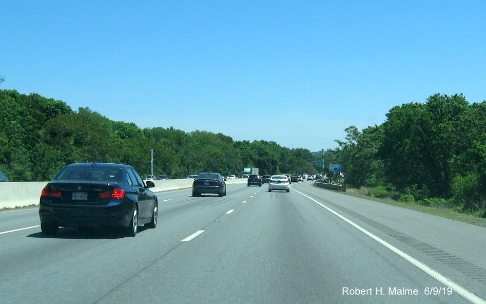 Image of recently placed support posts for future 1/2 mile advance sign for I-95 exit on I-90/Mass Pike East in Weston in June 2019