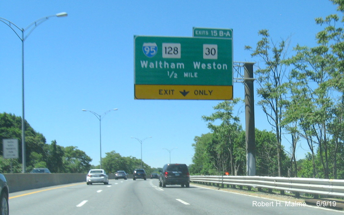 Image of contractor tag at site of foundation for future 1/2 mile advance overhead sign for I-95/To MA 30 exit on I-90/Mass Pike West in Newton