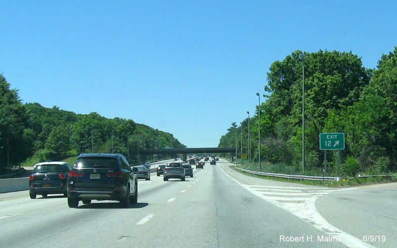 Image of recently placed wide exit gore sign that would fit a 3 digit milepost number for MA 9 exit on I-90/Mass Pike West in Framingham