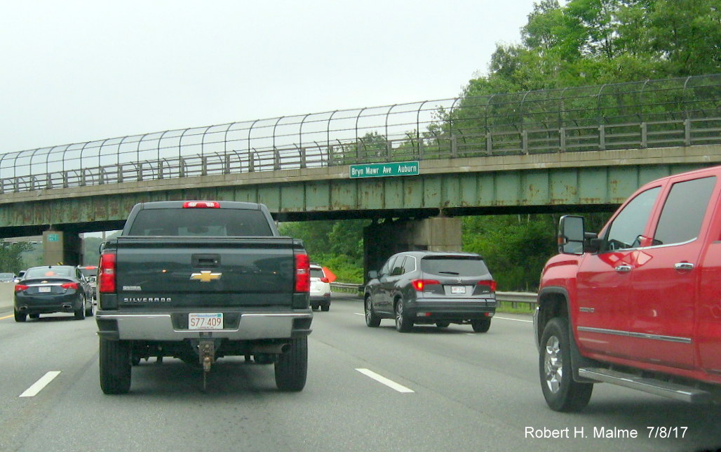 Image of new street and city signage being placed along the I-90/Mass Pike west roadway
