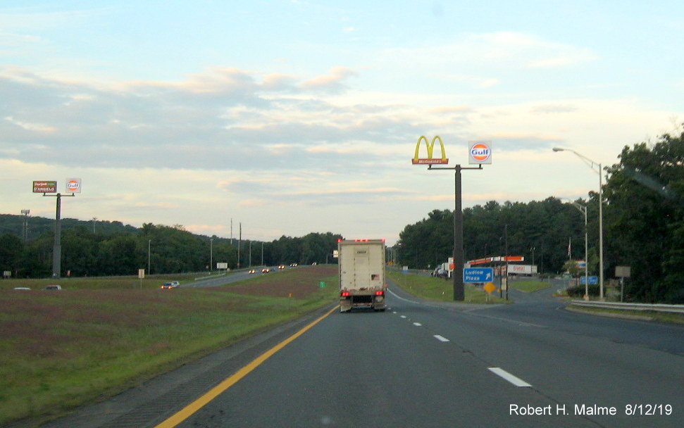 Image of new entrance ramp sign for Ludlow (Service) Plaza with mixed case lettering on I-90/Mass Pike East in Aug. 2019