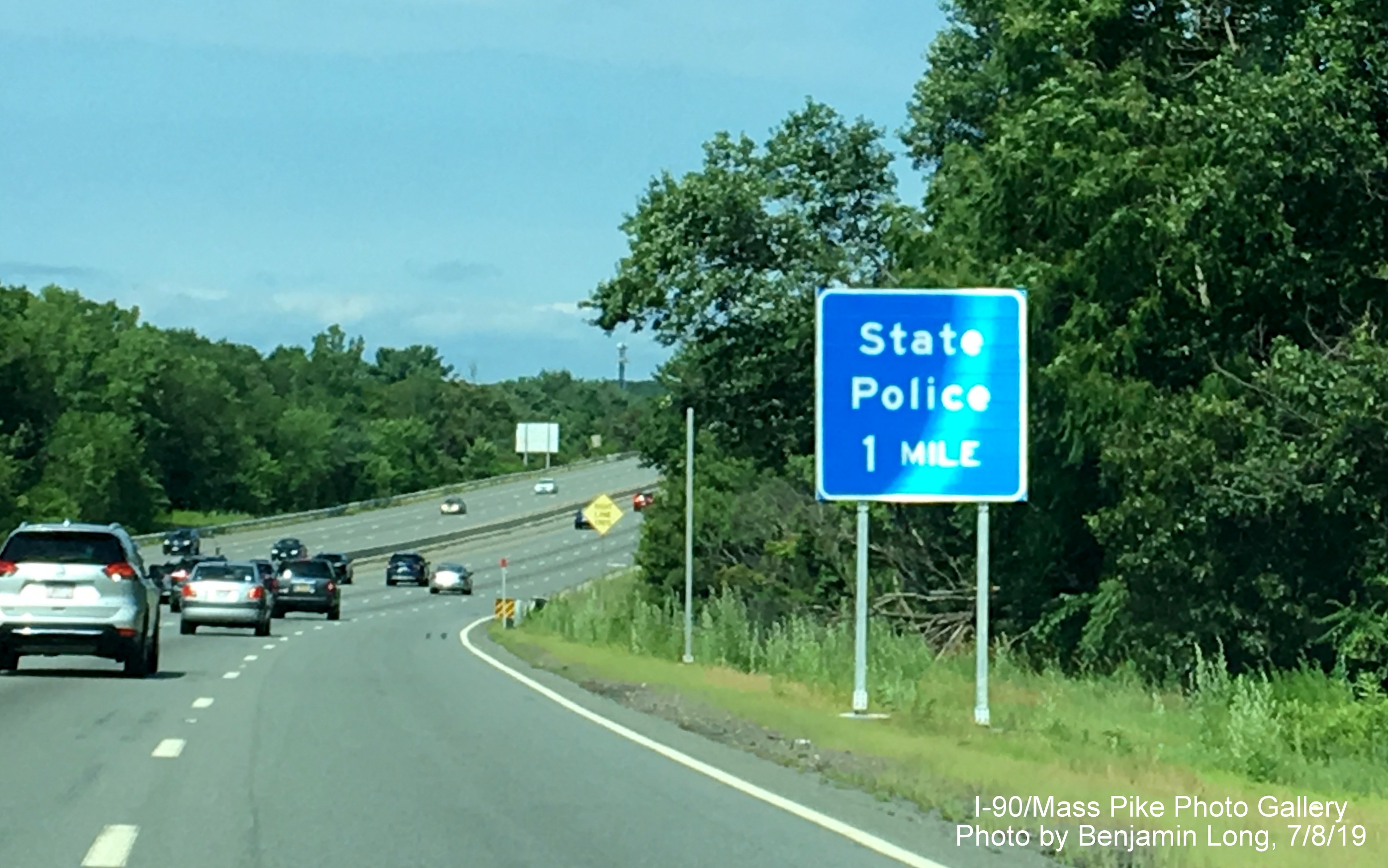 Image of recently placed blue 1-mile sign for State Police Barracks on I-90/Mass
Pike West in Weston, by Benjamin Long