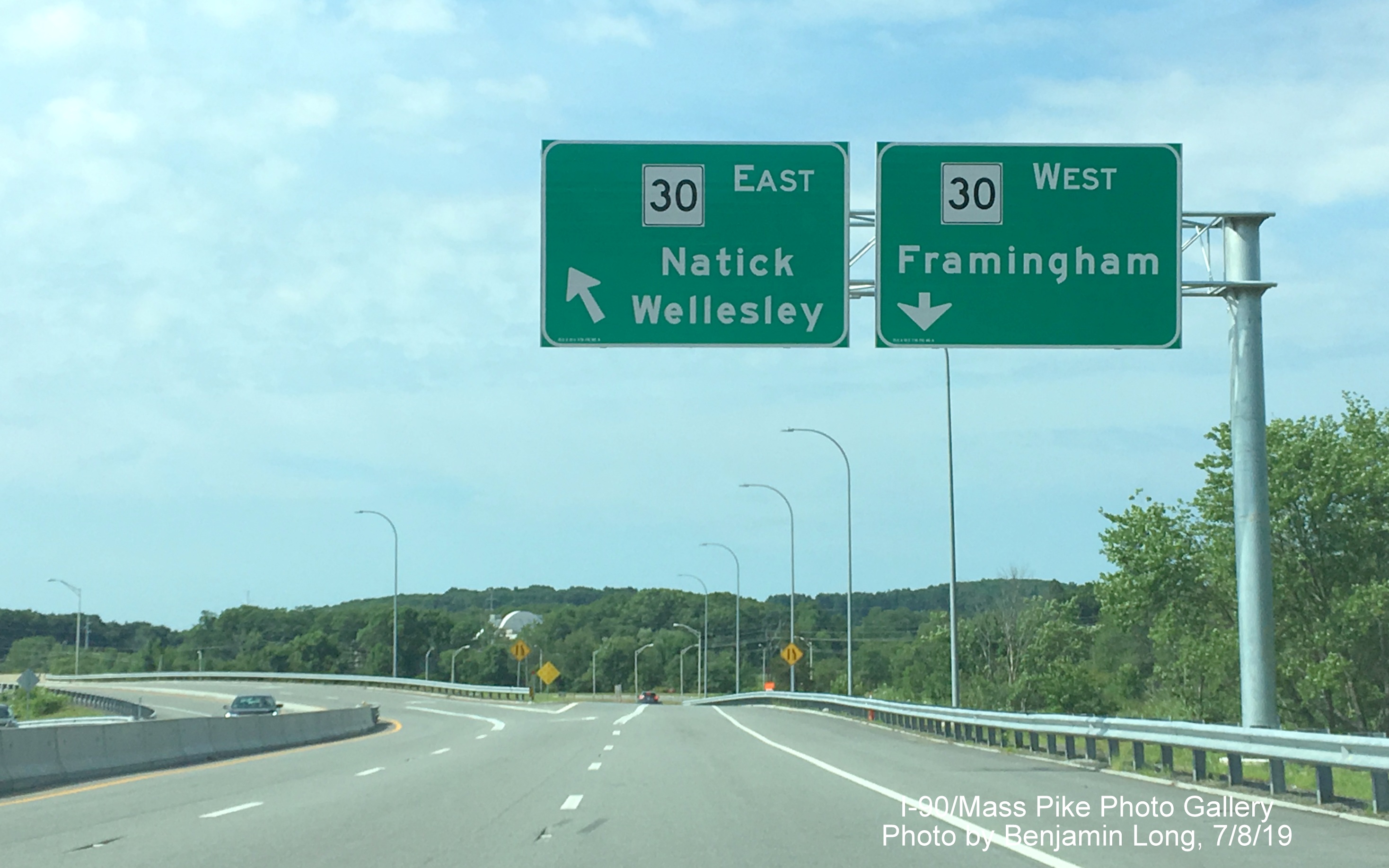 Image of recently placed two overhead signs on cantilever post for MA 30 exit ramps on
ramp from I-90/Mass Pike West, by Benjamin Long