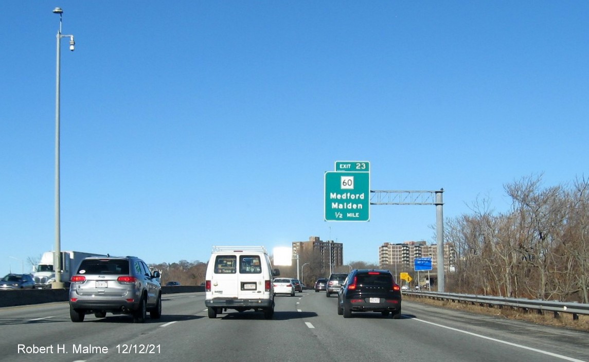 Image of 1/2 mile advance overhead sign for MA 60 exit with new milepost based exit number on I-93 North 
                                          in Medford, December 2021