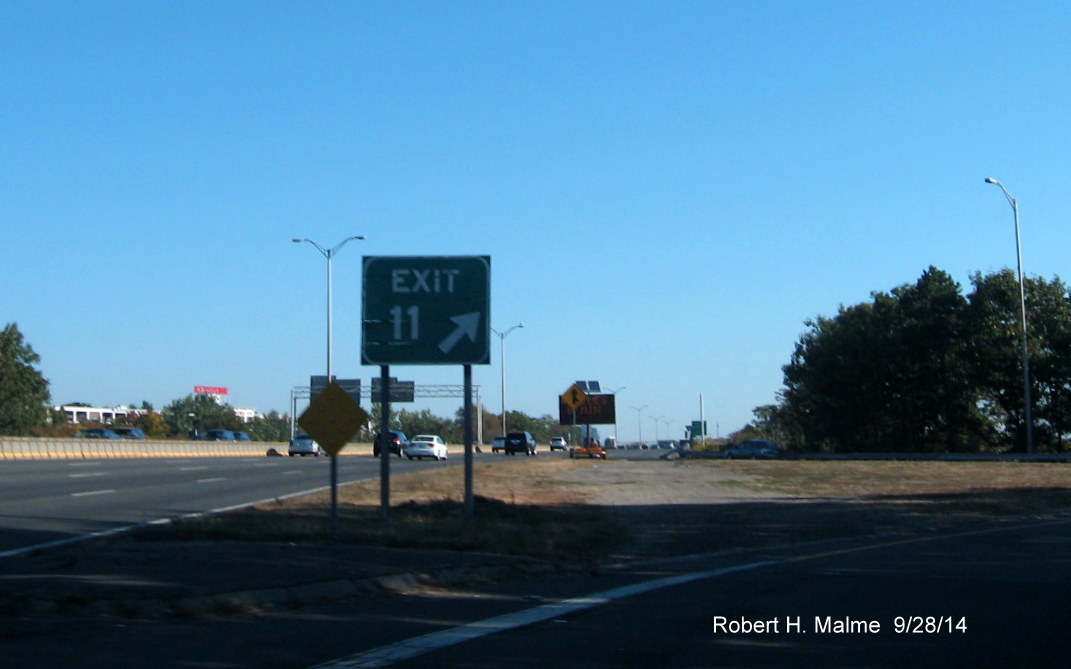 Image of, in distance, new support posts for future overhead signs on I-93 in Milton