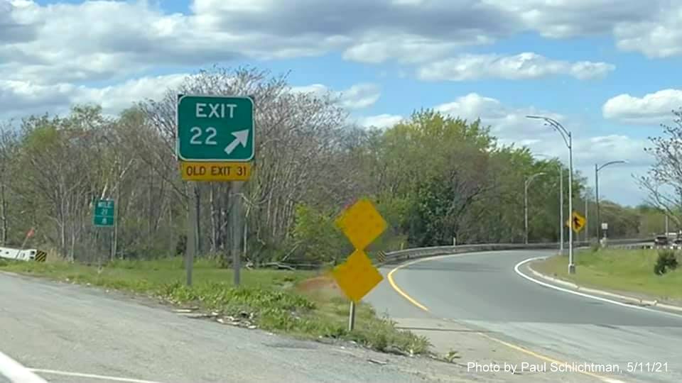 Image of gore sign for MA 16 West exit with new milepost based exit number and yellow Old Exit 31 sign 
                                           attached below on I-93 in Medford, by Paul Schlichtman, May 2021