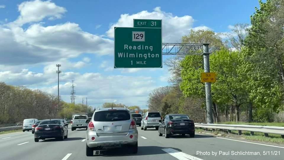 Image of 1 mile advance overhead sign for MA 129 exit with new milepost based exit number and yellow
                                           Old Exit 38 advisory sign on support on I-93 North in Wilmington, by Paul Schlichtman, May 2021