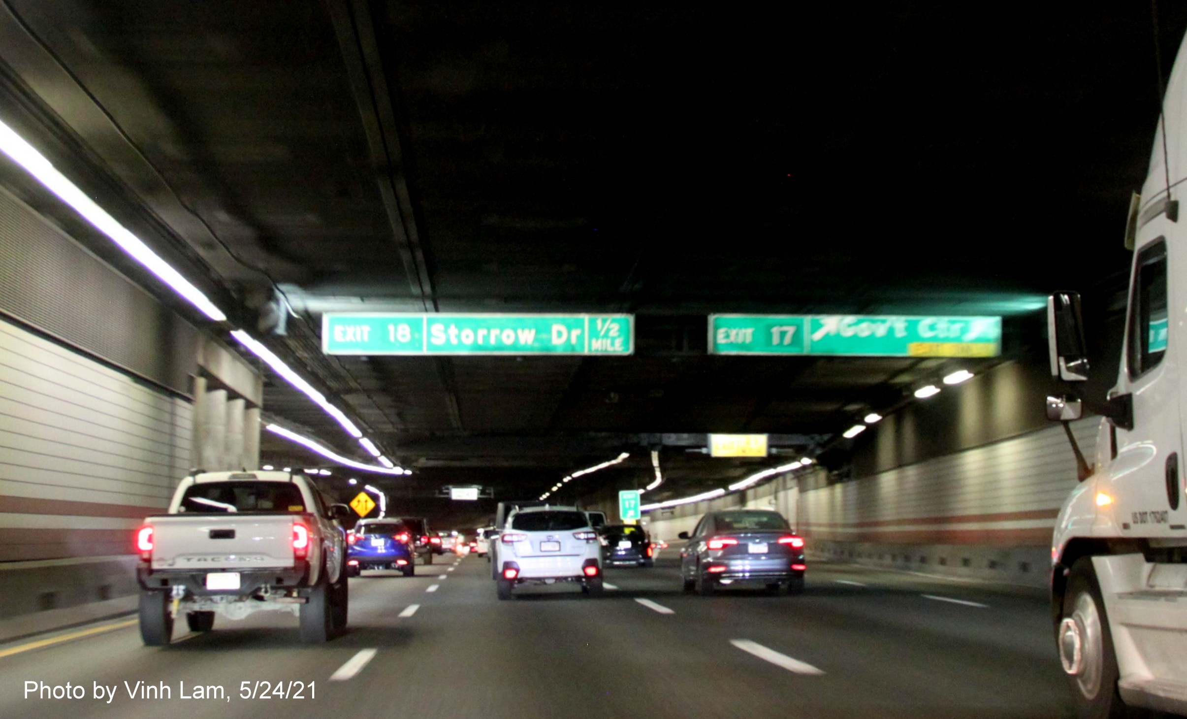 Image of overhead advance signs for Government Center and Storrow Drive exits with new milepost based 
      exit numbers on I-93 North in Boston, by Vinh Lam, May 2021