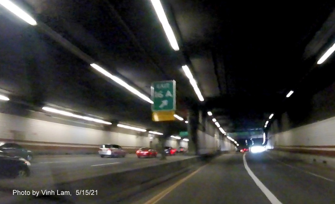 Image of gore sign for I-90/South Station exit with new milepost based exit number and yellow Old Exits 20 A/B sign attached below on I-93 South in Boston, by Vinh Lam, May 2021 