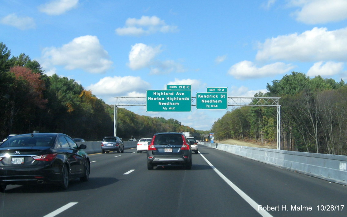 Image of revised advance overhead exit signs for Kendrick St and Highland Ave on I-95 North in Needham