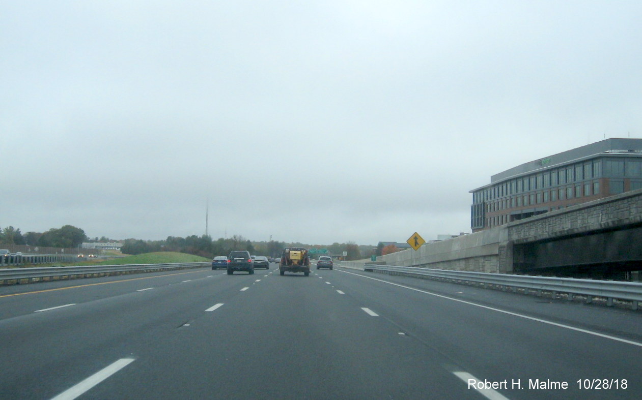 Image of 4 lanes of traffic passing by TripAdvisor building and Kendrick Street onramp in completed Add-A-Lane Project work zone in Needham