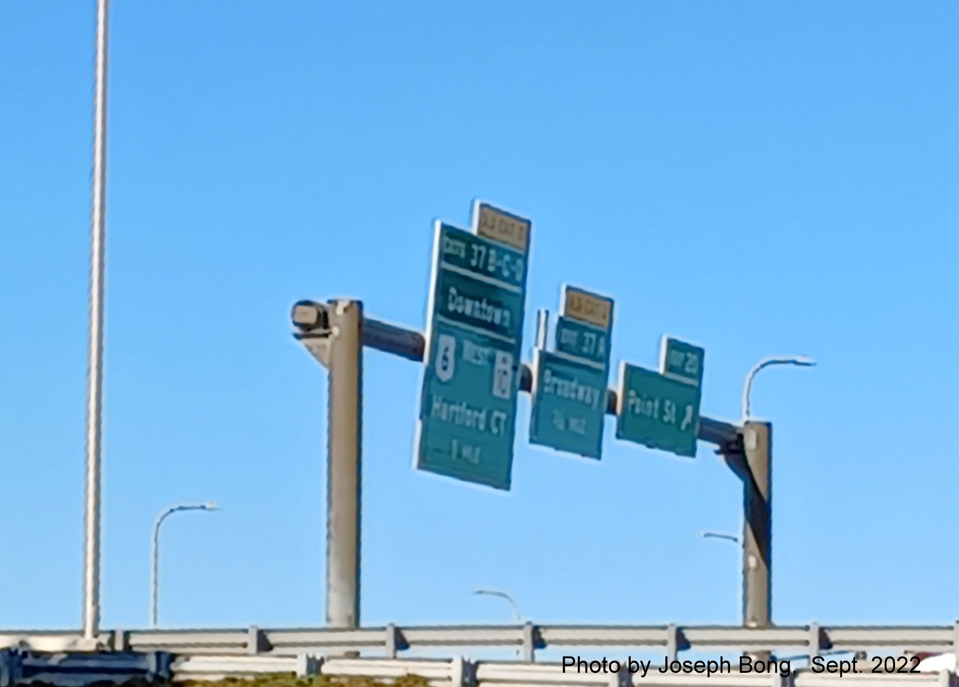 Image of overhead signs for US 6 West/RI 10 exits with new milepost based exit numbers,
                                         by Joseph Bong, September 2022