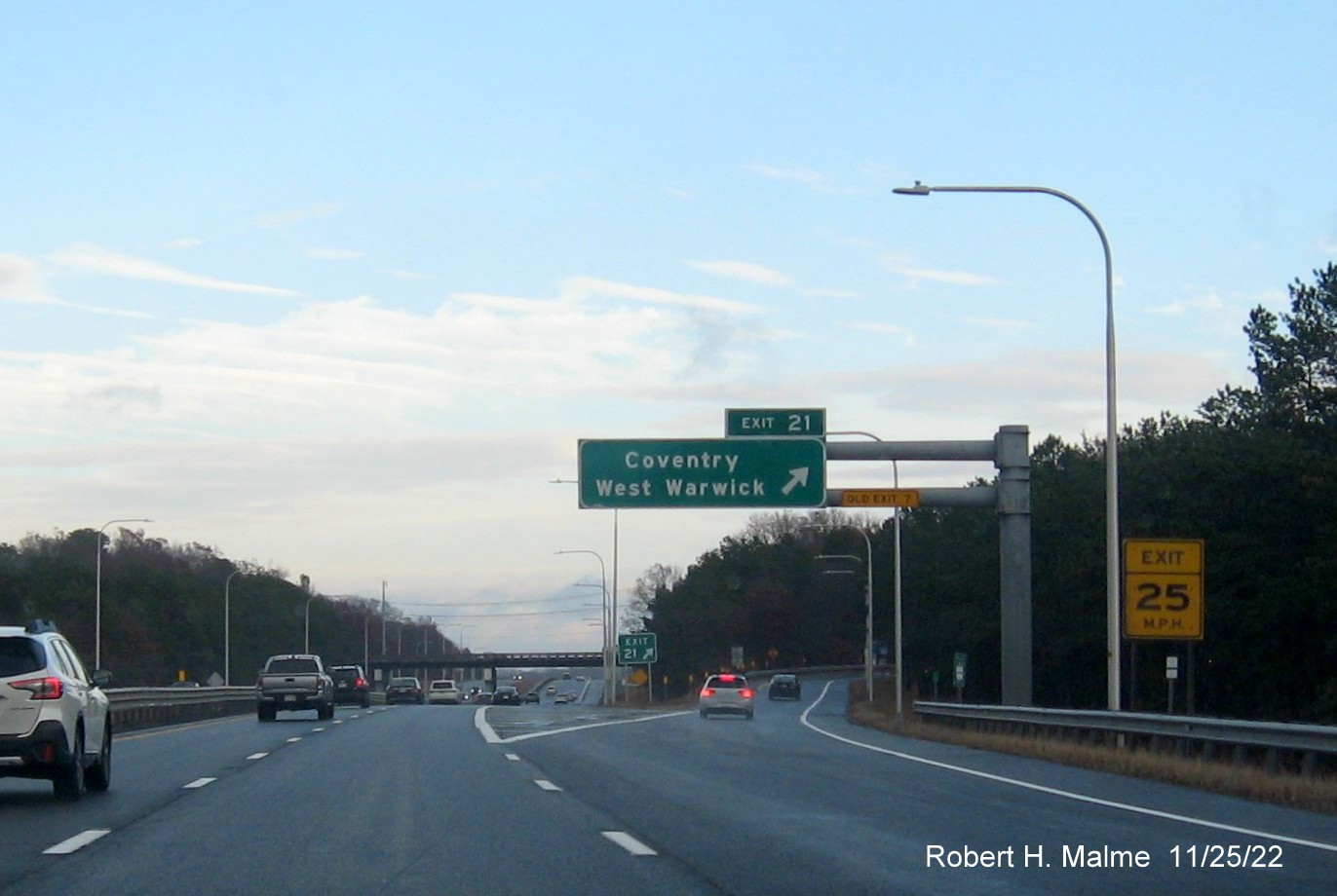 Image of overhead ramp sign for Coventry/West Warwick exit with new milepost based exit number and Old 
                                          Exit 7 sign on support post on I-95 North, November 2022