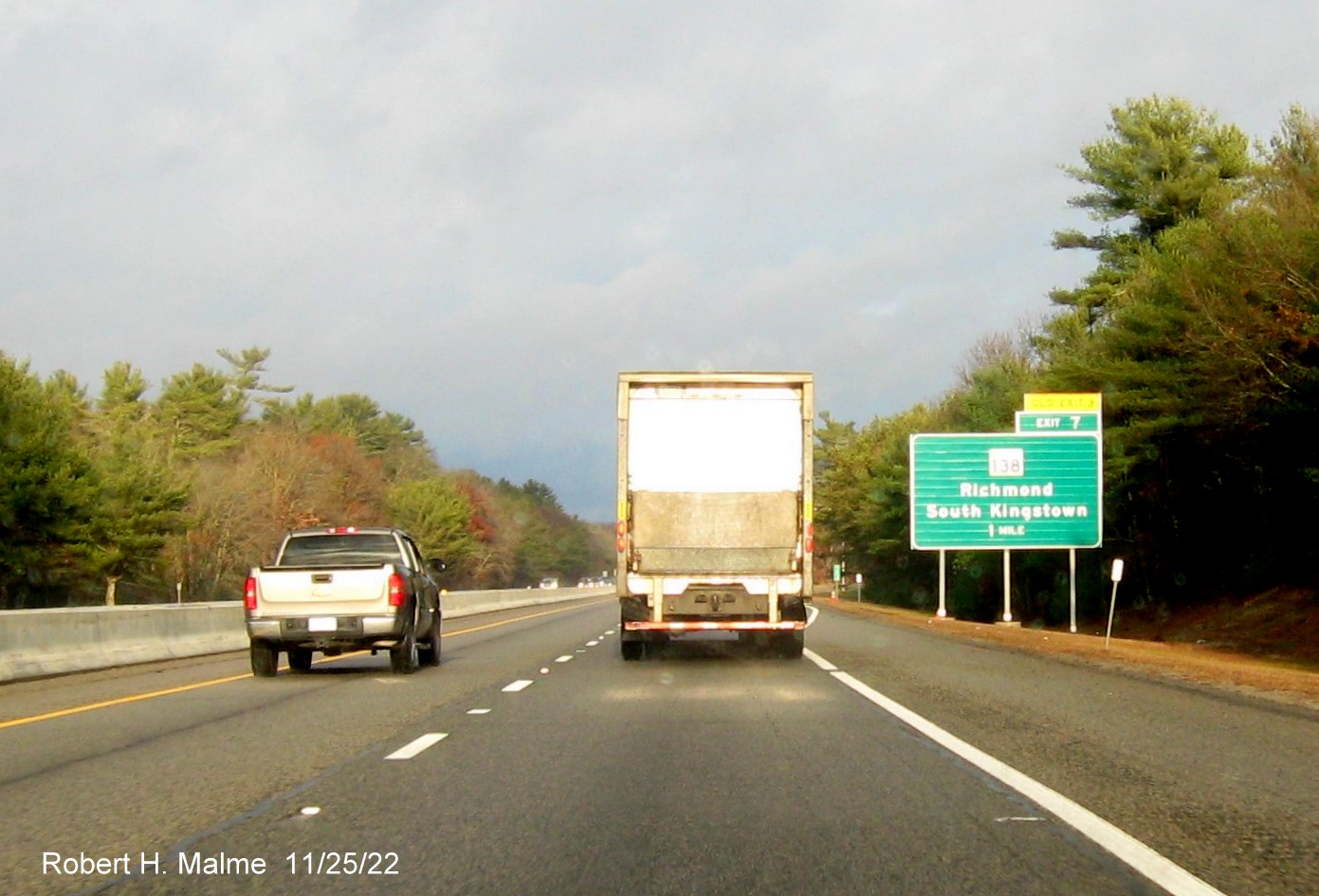 Image of ground mounted 1 mile advance sign for RI 138 exit with new milepost based exit number and 
                                         yellow Old Exit 3 sign above exit tab on I-95 North in Wyoming, November 2022