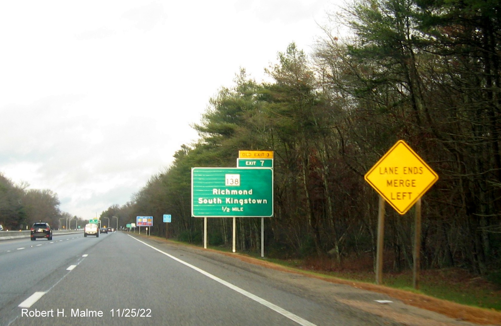 Image of ground mounted 1/2 mile advance sign for RI 138 exit with new milepost based exit number and 
                                         yellow Old Exit 3 sign above exit tab on I-95 North in Wyoming, November 2022