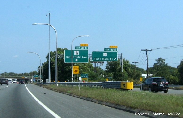 Image of overhead ramp signs for US 1/RI 126 exits with new milepost based exit numbers and yellow Old Exit 25A and 25B tabs on top on I-95 North in Providence, September 2022
