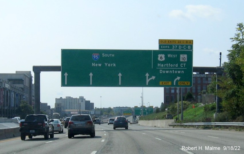 Image of 1/4 mile advance arrow-per-lane sign for US 6 West/RI 10 exit with new milepost based exit numbers and yellow Old Exit 22 A-C tab on top on I-95 South in Providence, September 2022