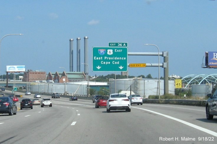 Image of 2 miles advance overhead sign for I-195/US 6 East exit with new milepost based exit number and yellow Old Exit 19 sign on top of exit tab on I-95 North in Providence, September 2022