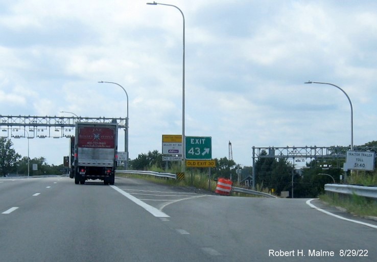 Image of gore sign for Roosevelt Avenue exit on I-95 South in Attleboro MA with new milepost based exit number
      and yellow Old Exit 30 sign below, August 2022