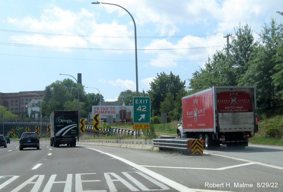 Image of gore sign US 1/RI 15 and US 1 to RI 114 exits with new milepost based exit number with yellow Old 
       Exit 29 sign below on I-95 South in Pawtucket, August 2022