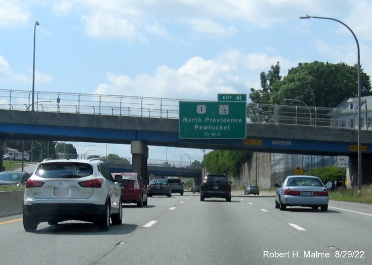 Image of bridge mounted 1/2 mile advance sign for US 1/RI 15 exit with new milepost based exit number on I-95 South in Pawtucket, August 2022