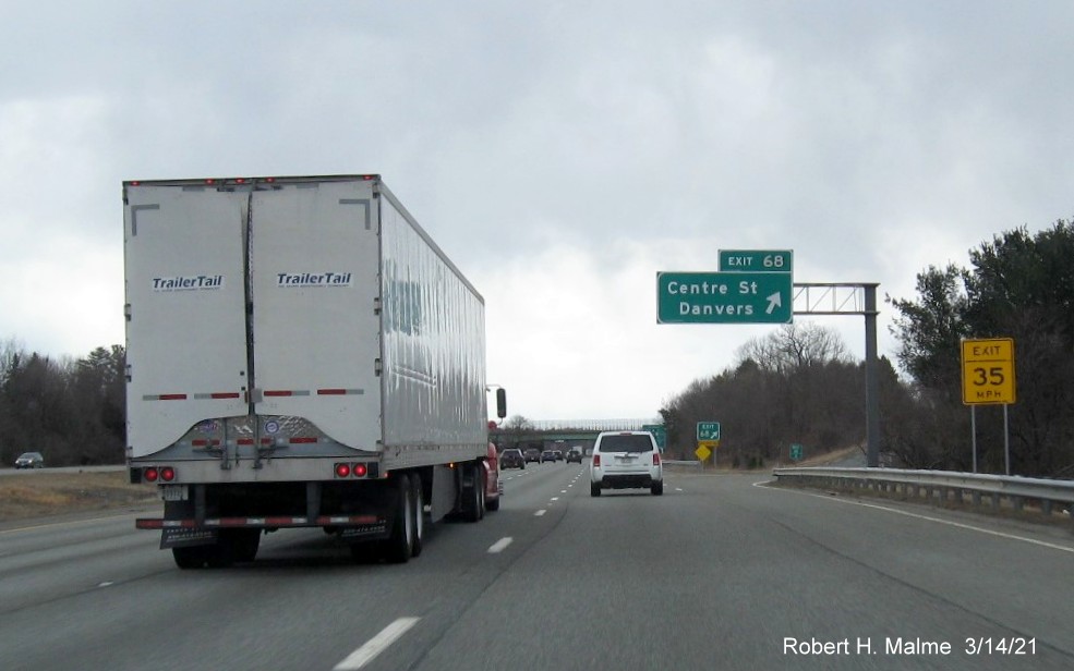 Image of overhead ramp sign for Centre Street exit with new milepost based exit number and gore sign with new number and yellow Old Exit 48 advisory sign on I-95 South in Danvers, March 2021