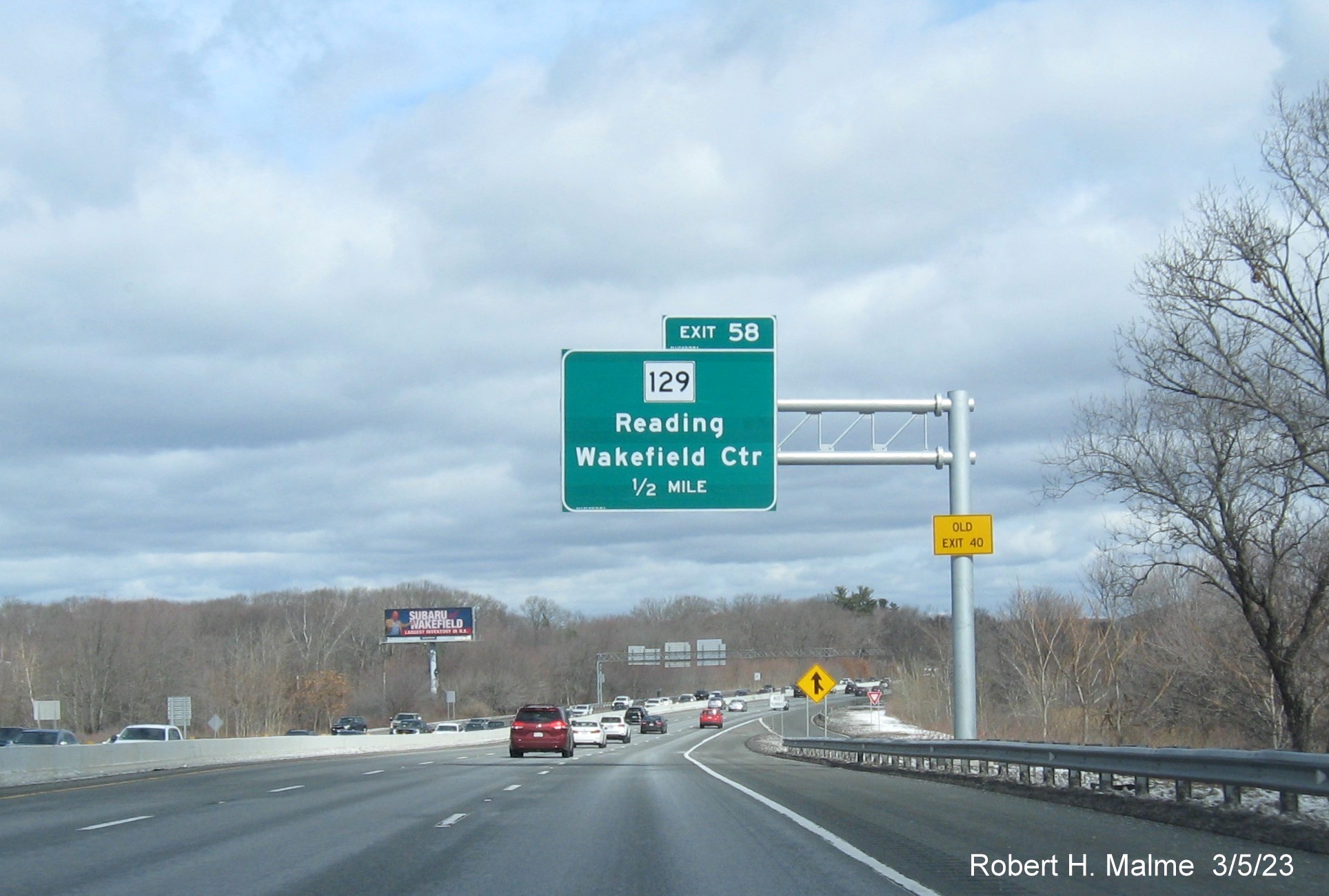 Image of recently placed 1/2 mile advance overhead sign for MA 129 exit on
                                     I-95/MA 128 North in Wakefield, March 2023