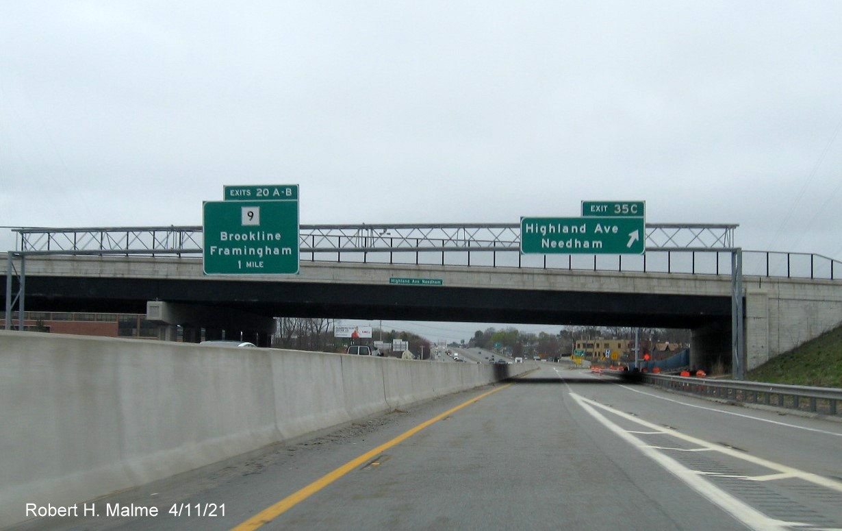 Image of overhead ramp sign for Highland Avenue West exit with new milepost 
                                            based exit numbers on C/D ramp from I-95/MA 128 North in Needham, April 2021