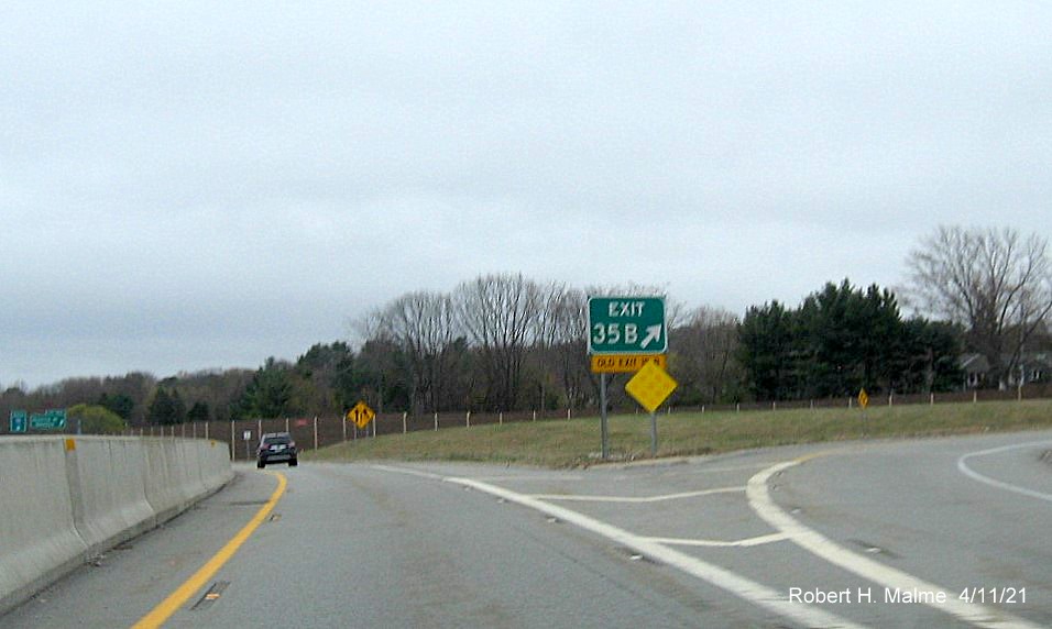 Image of gore sign for Highland Avenue East exit with new milepost based 
                                            exit number on C/D ramp from I-95/MA 128 South in Needham, April 2021
