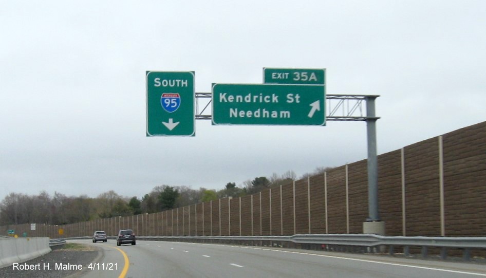 Image of overhead signage at ramp to Kendrick Street exit with new milepost based 
                                            exit number on C/D ramp from I-95/MA 128 South in Needham, April 2021