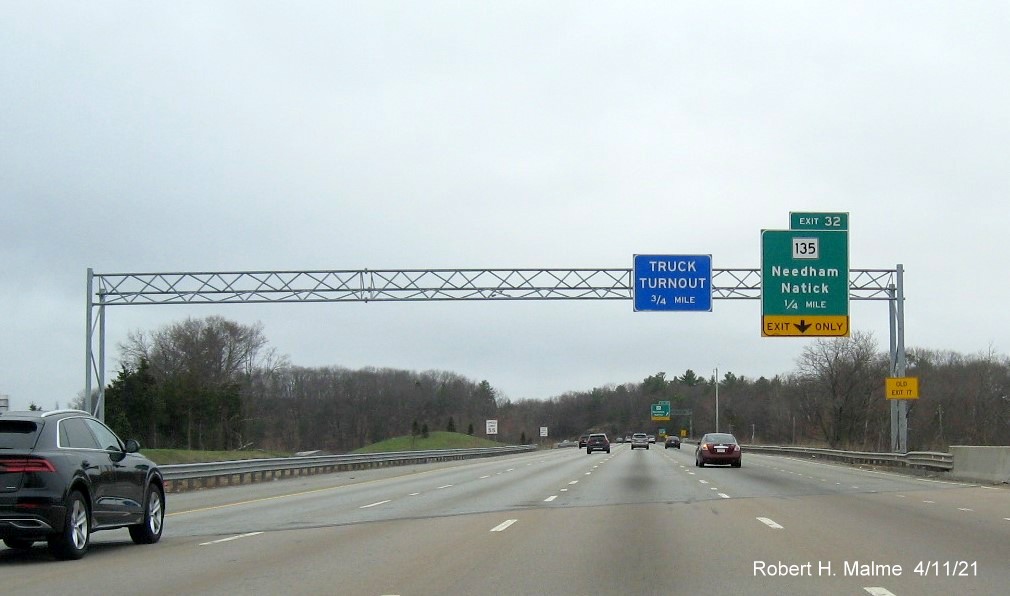 Image of 1/4 Mile advance overhead sign for MA 135 exit with new milepost based exit number and yellow 
                                           Old Exit 17 advisory sign on support on I-95/MA 128 South in Dedham, April 2021