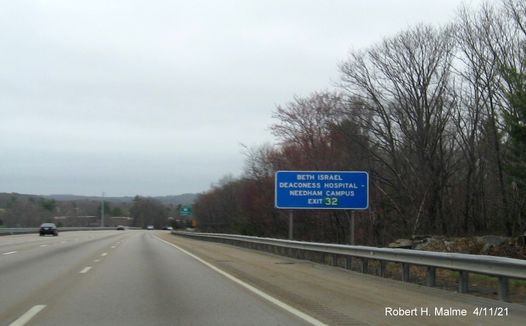Image of auxiliary blue hospital sign for MA 135 exit with new milepost based exit number in green 
                                           on I-95/MA 128 North in Dedham, April 2021
