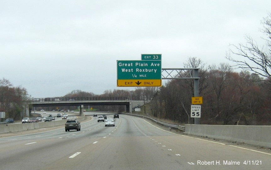 Image of 1/4 mile advance overhead sign for Great Plain Avenue exit with new milepost based exit number and yellow Old Exit 18 advisory sign on support on I-95/MA
                                           128 North in Dedham, April 2021