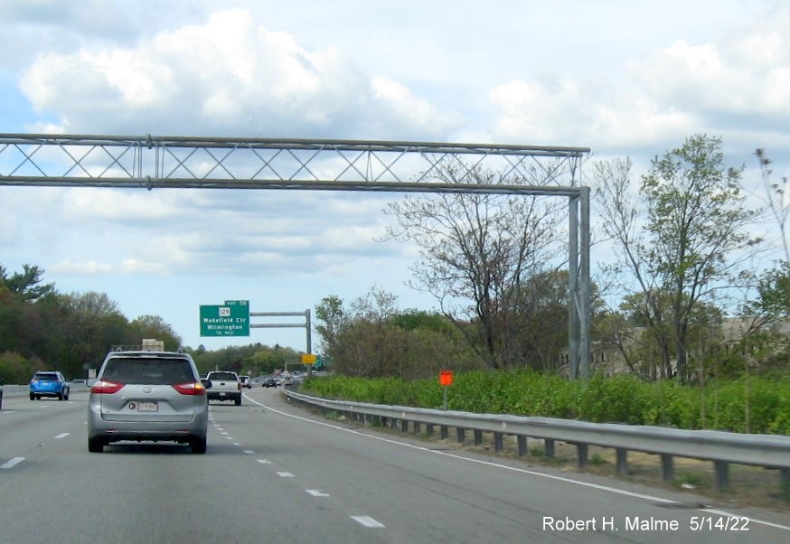 Image of contractor future sign placementtag and concrete foundation for new MA 129 advance sign on I-95/MA 128 North in
      Wakefield, May 2022