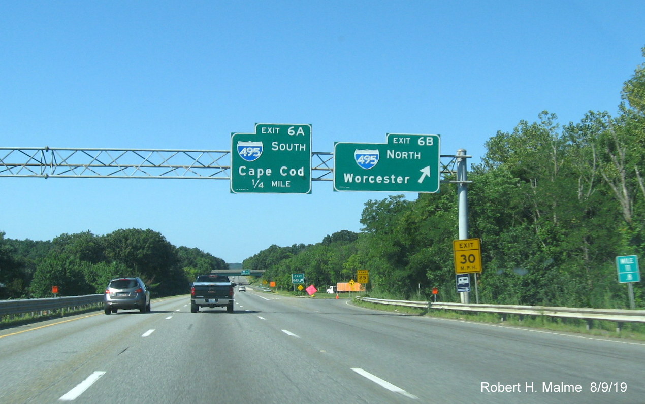 Image of orange contractor tags marking site of future overhead signs at ramp to I-495 North on I-95 South in Foxboro