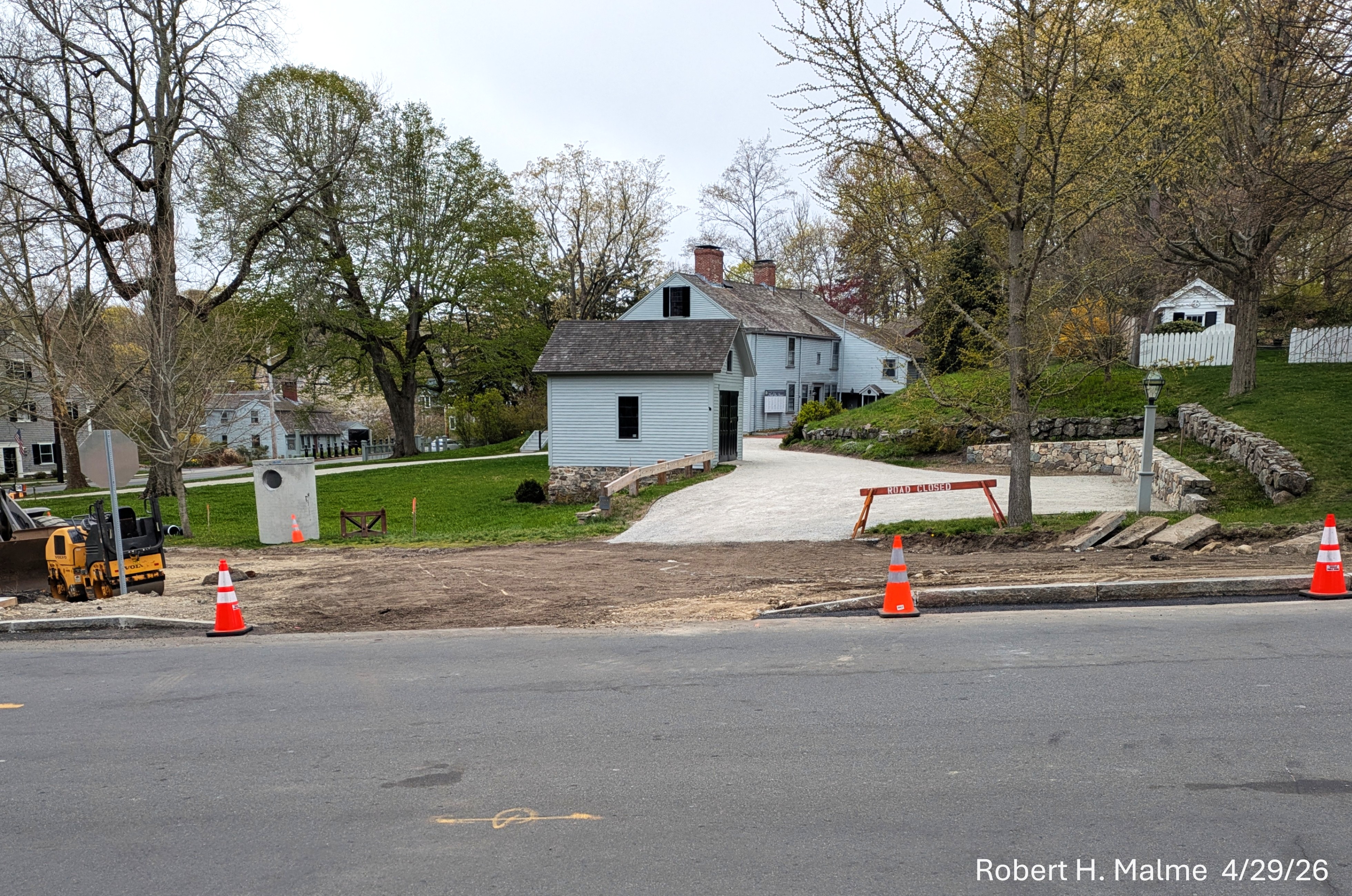 Image from across Lincoln Street of new curbing having been added to the west side
	of the street with a gap for the future Benjamin Lincoln House driveway extension, April 2026