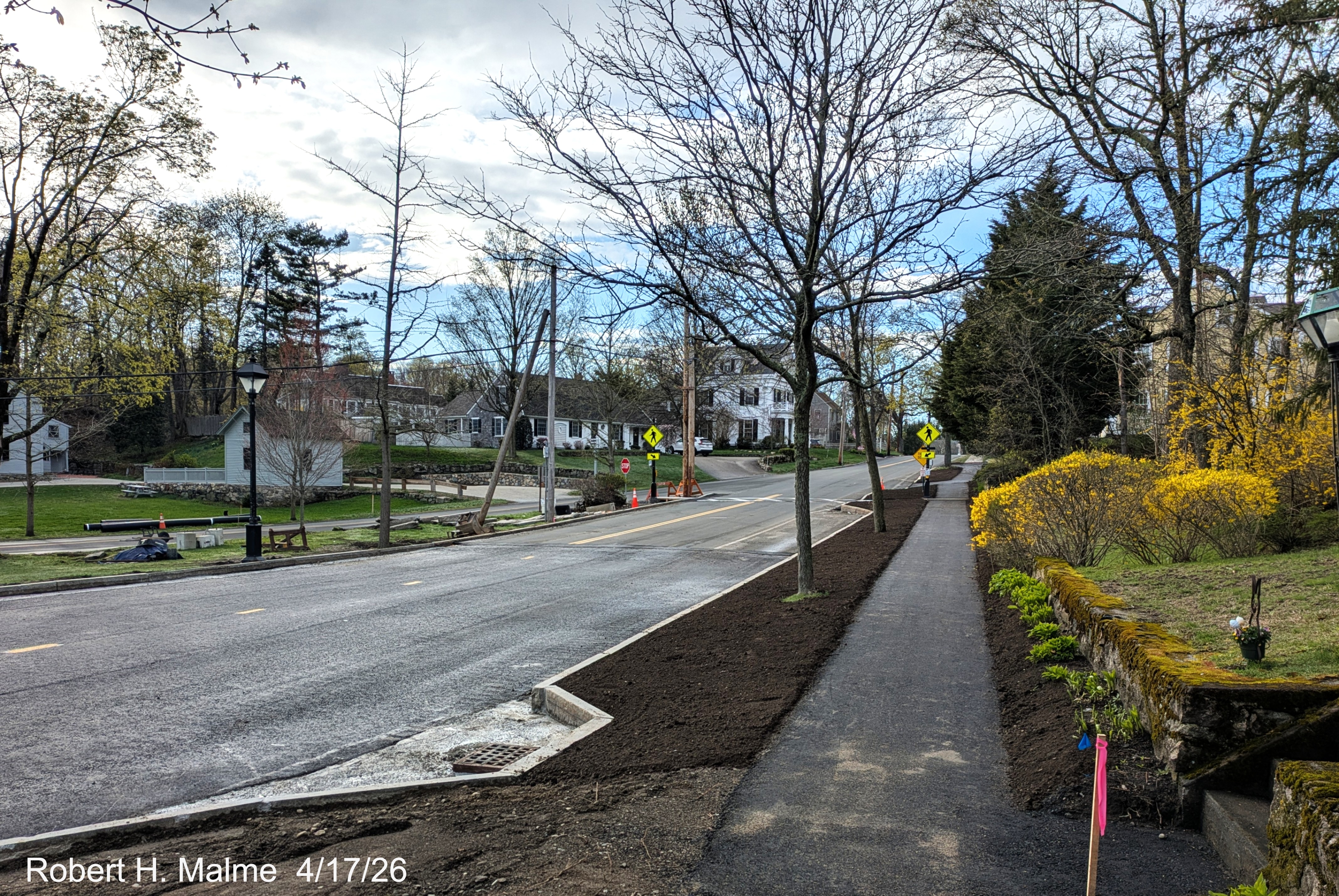 Image of new landscaping along the realigned east side of Lincoln Street and completed
	drainage grate,	April 2026