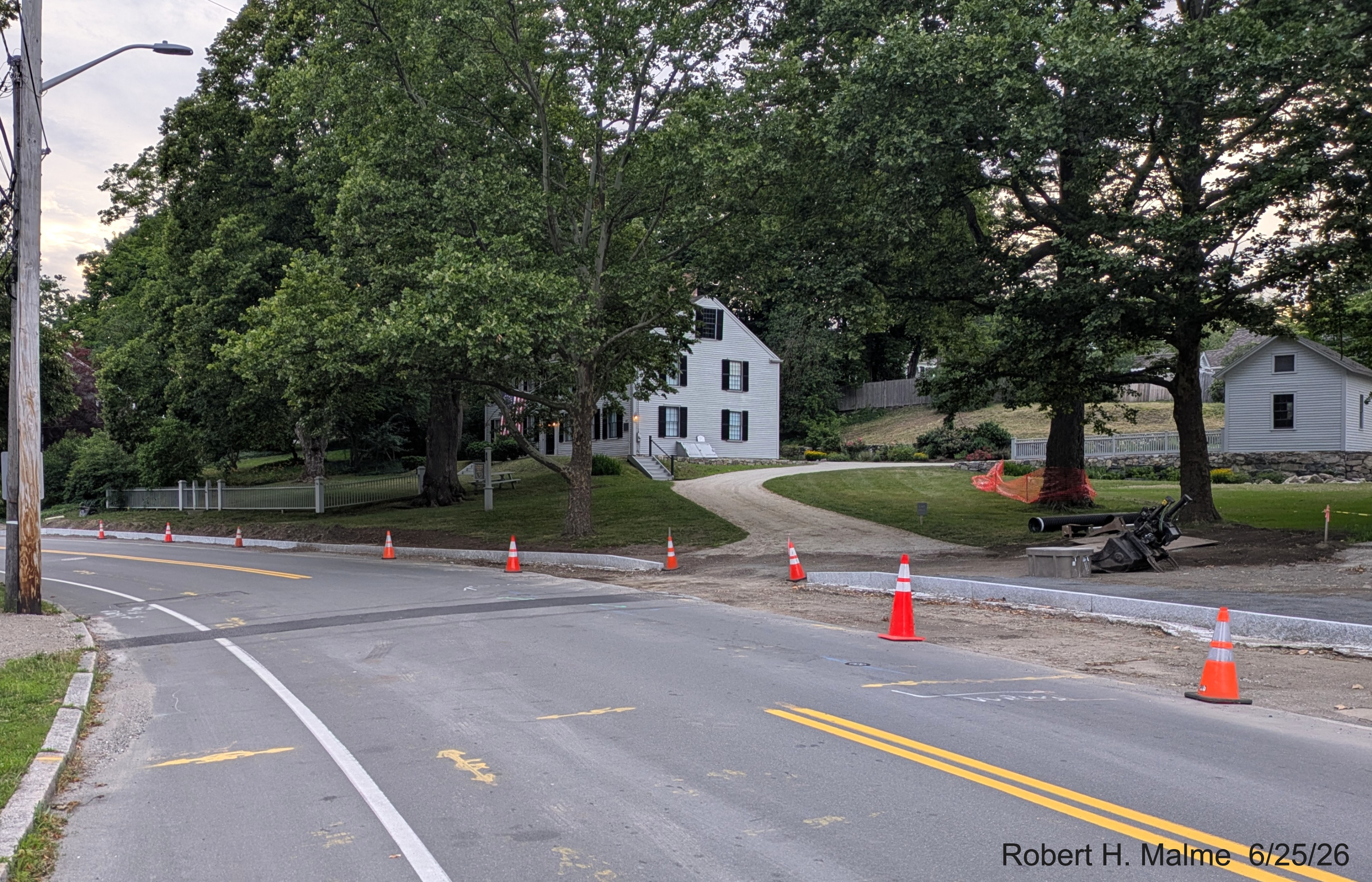 Image taken of completed granite curbing heading west along North Street, with a gap
	for the Benjamin Lincoln House driveway, June 2026