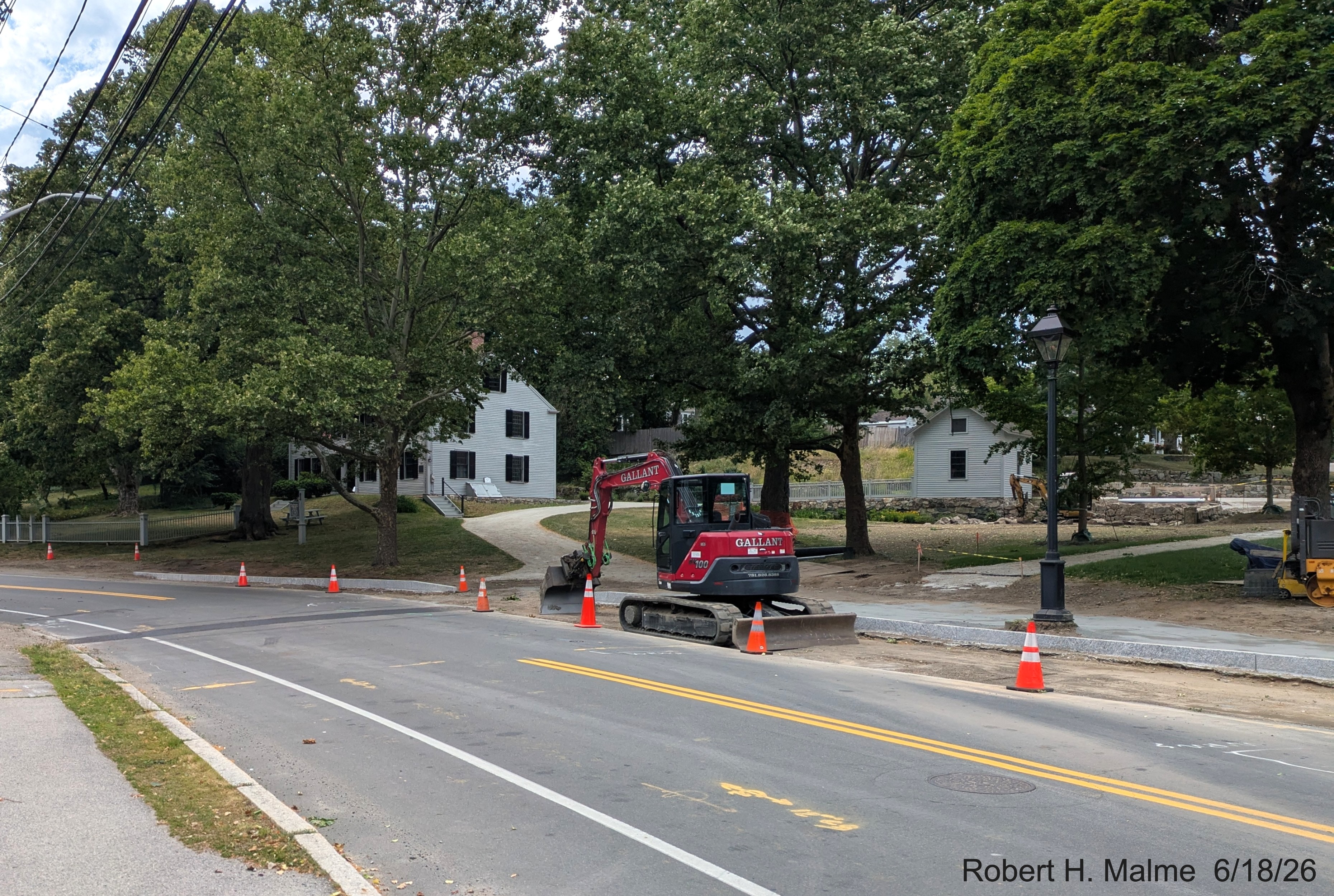 Image taken along North Street, showing curbing work near completion around the driveway
	for the Benjamin Lincoln House, June 2026