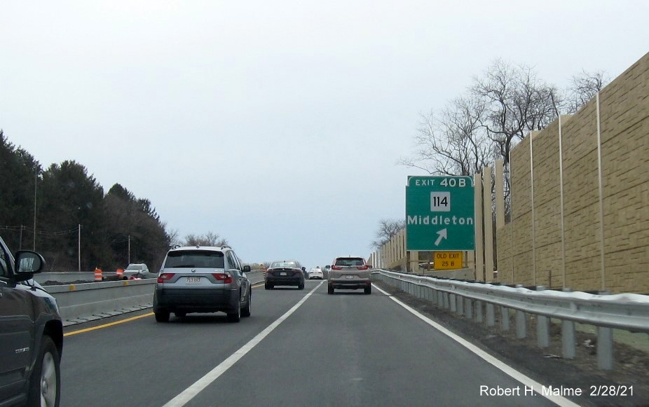 Image of ground mounted 1/4 mile advance sign for MA 114 West exit with new milepost based exit number 
                                             and yellow old exit number tab on left support post on MA 128 South in Peabody, February 2021