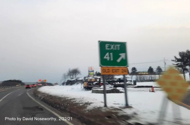 Image of gore sign for the Endicott Street exit with new milepost 
      based exit number and yellow old exit sign on the right support post on MA 128 North in Danvers, photo by David Noseworthy, February 2021