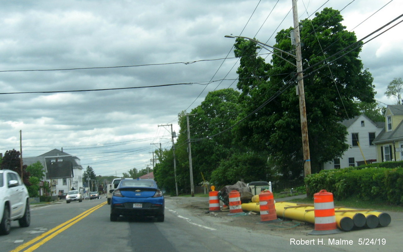 Image of utility pipes awaiting placement alongside MA 18 South in Widening Project work area in Weymouth between South Shore Hospital and Pleasant Street