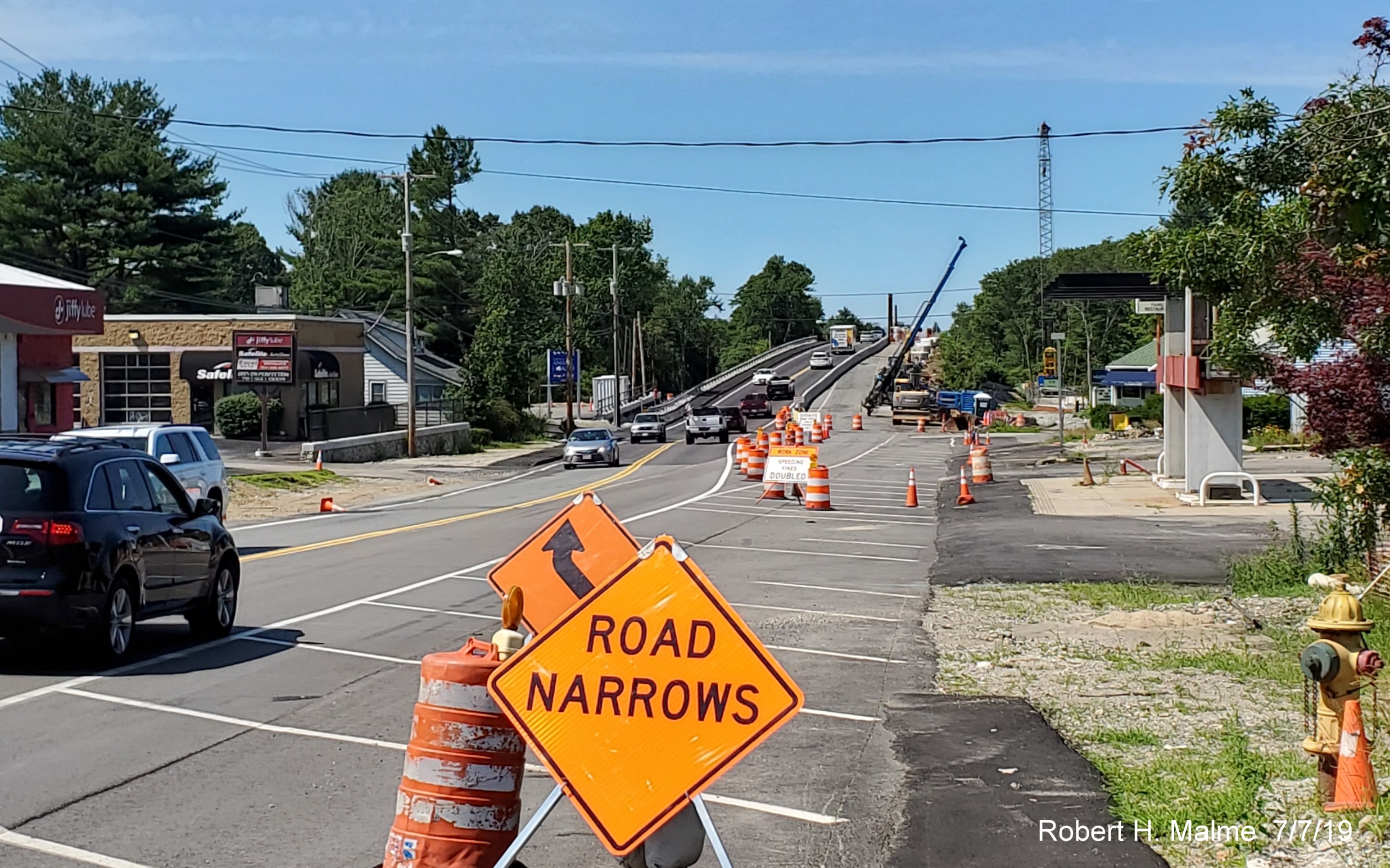 Image of view looking north on MA 18 by South Weymouth Commuter Rail Station of new widened railroad bridge construction in July 2019