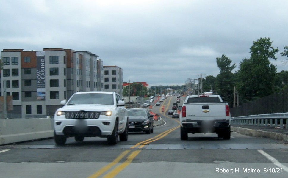 Image of traffic on MA 18 South on commuter railroad bridge still under construction in South Weymouth, August 2021