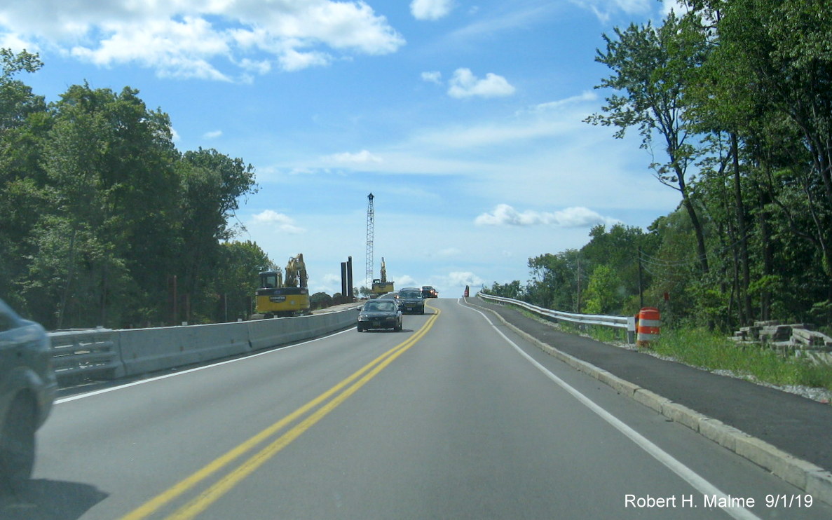 Image of MA 18 traffic using completed half of commuter rail bridge being replaced as part of MassDOT widening project in South Weymouth