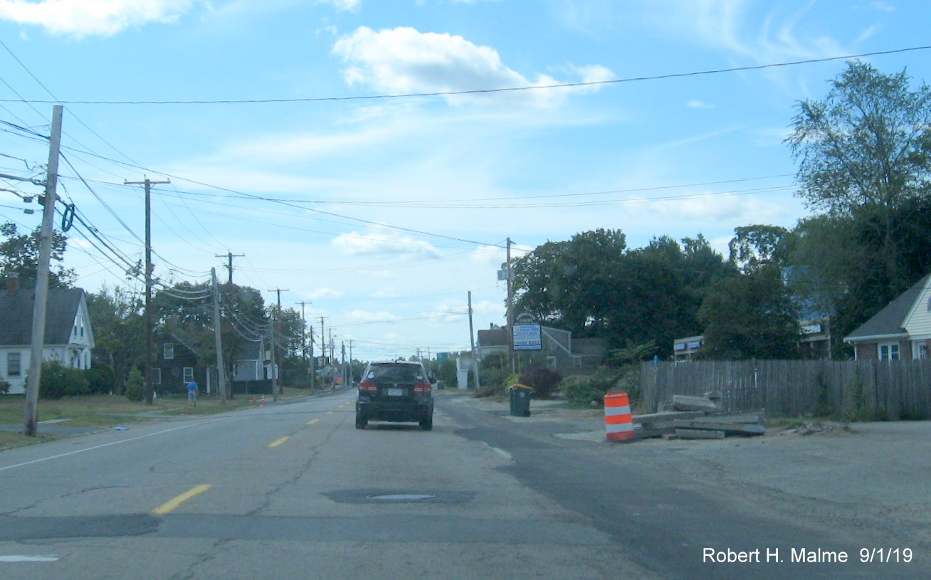 Image of MA 18 South traffic traveling by fire station in MassDOT widening project work zone in Abington