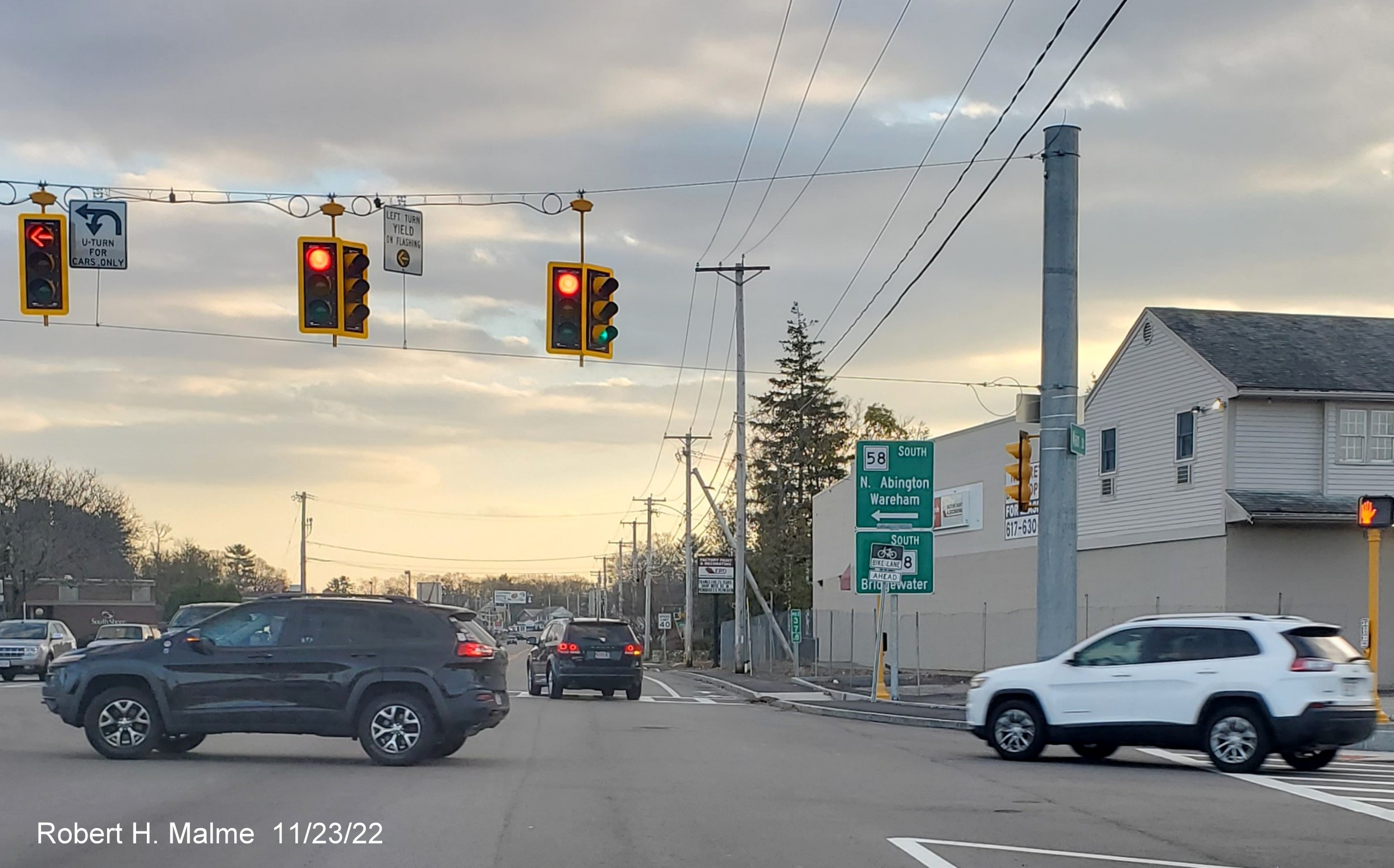 Image of South MA 18 reassurance marker before completed commuter railroad bridge in South Weymouth, November 2022