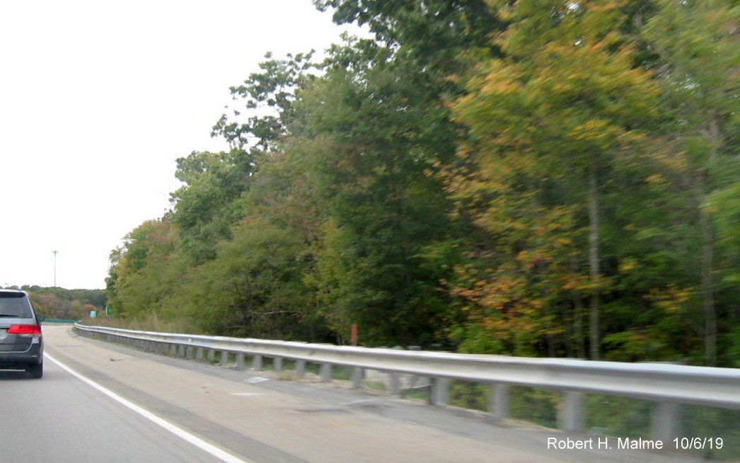 Image of foundation (behind guardrail) for future 1 mile advance sign for MA 104 exit on MA 24 South in Bridgewater